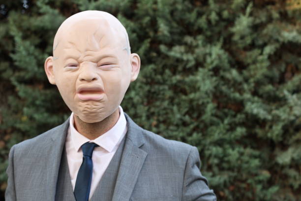 Spooky senior bald businessman crying.