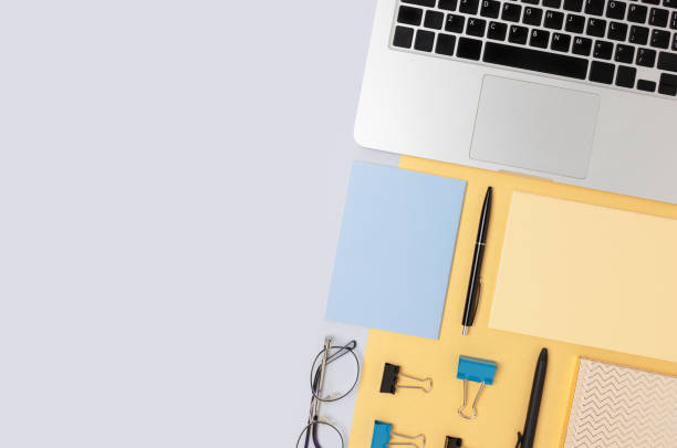 istock Organized workspace for homeschooling with laptop and office supply on a blue background. 1299745655