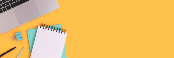istock Banner with laptop and stationery on a yellow background. 1299745690