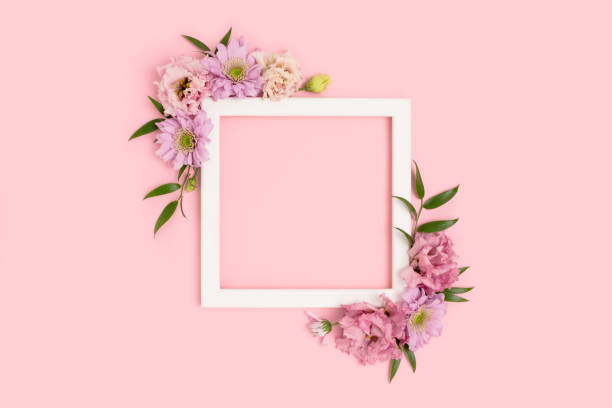 istock Square flower frame made of eustoma on pink background. 1299745725