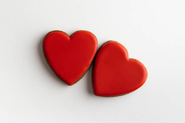 istock Two red gingerbread hearts on white background, top view. Valentines day 1299746188