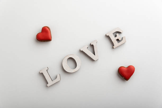istock Word Love white letters and small red hearts. White background 1299746238