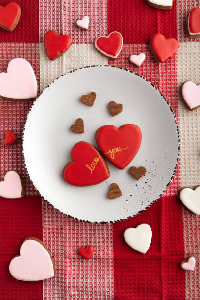 istock Heart shaped cookies on plate and tablecloth. Baking with love for Valentines day 1299746292