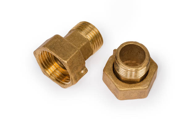 istock Brass threaded plumbing connections with nuts on a white background 1299749213