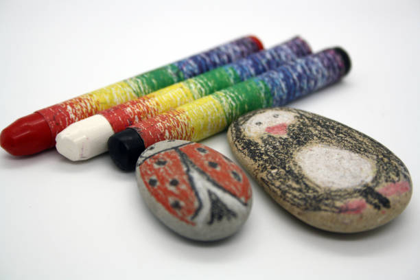 istock Drawing on sea stones. Classes with children. 1299749508