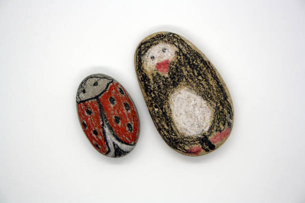 istock Drawing on sea stones. Classes with children. 1299749714