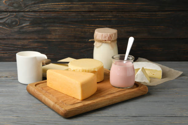 istock Different fresh dairy products on gray wooden background 1299749732