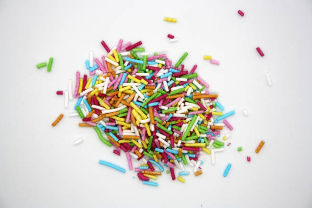 istock Colorful confectionery sprinkles on a white background. 1299749744
