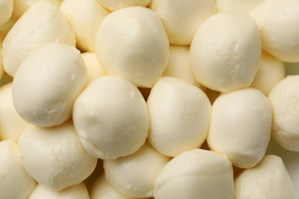 istock Fresh mozzarella cheese on whole background, close up 1299749758