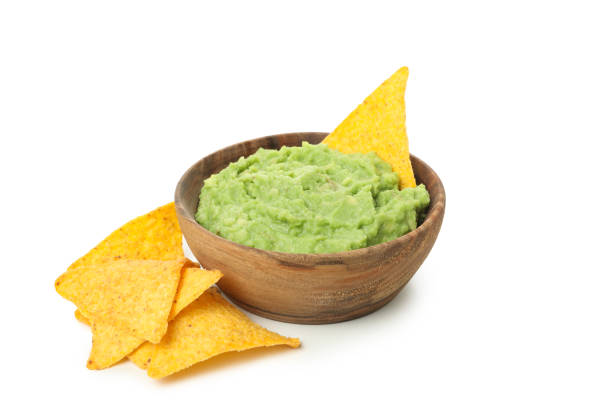 istock Bowl of guacamole and chips isolated on white background 1299750581