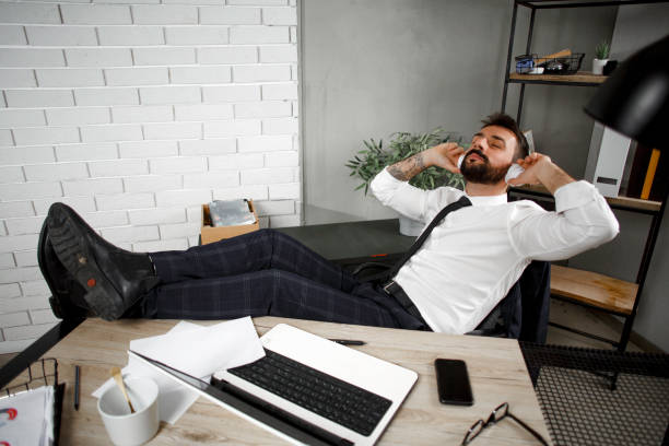 istock Young businessman with headphones singing at work. 1299750582