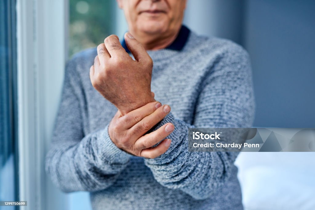 A bit of inflammation can cause a lot of pain Shot of an unrecognisable senior man suffering from wrist pain Arthritis Stock Photo