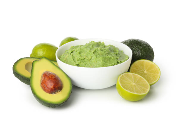 istock Bowl of guacamole, avocado and lime isolated on white background 1299750844