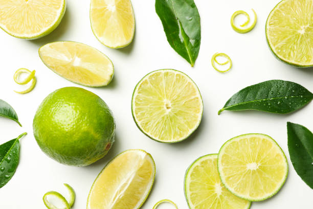 istock Fresh ripe limes, peel and leaves on whole background 1299751055