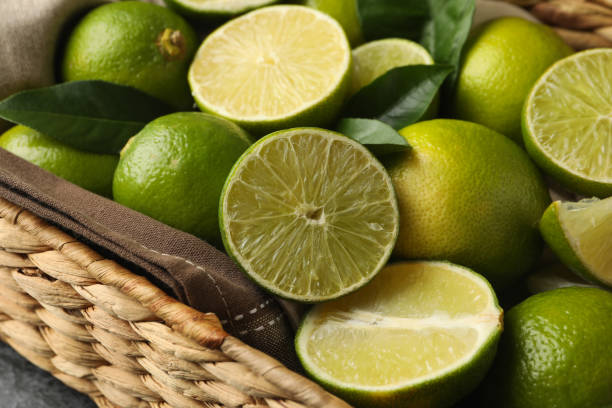 istock Basket with fresh ripe lime, close up 1299751124