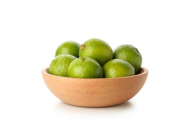 istock Bowl with ripe lime isolated on white background 1299751786