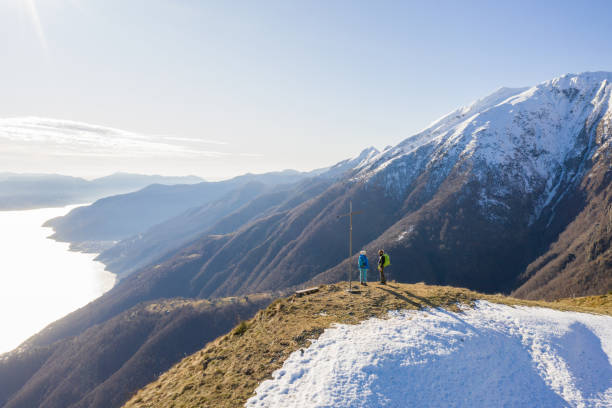 istock Drone view of couple contemplating view from mountain top 1299752019