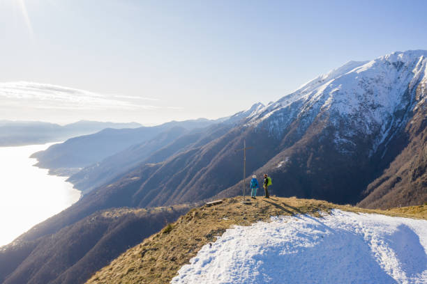 istock Drone view of couple contemplating view from mountain top 1299752147