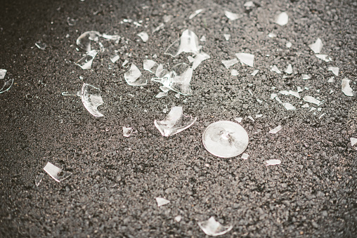 Shattered champagne glass on an asphalt