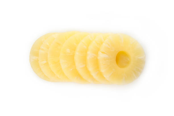 istock Ripe pineapple slices isolated on white background 1299755542