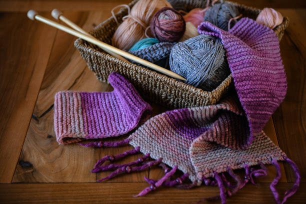 istock Accessories for knitting in basket ( yarn, needles) and scarf 1299755852
