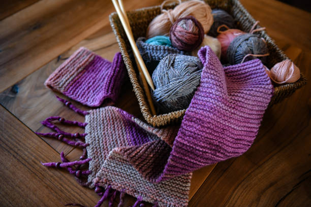 istock Accessories for knitting in basket ( yarn, needles) and scarf 1299756196