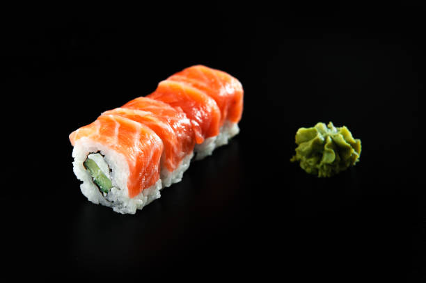 istock roll sushi with red fish and wasabi on a black background 1299757117