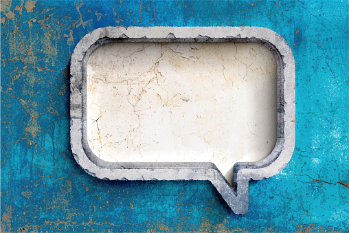 Vector Illustration of a speech bubble carved out of stone on a concrete wall. Grunge background with copy space.