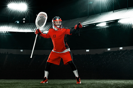 Lacrosse match, players, gear on the field, american sports themed photograph.