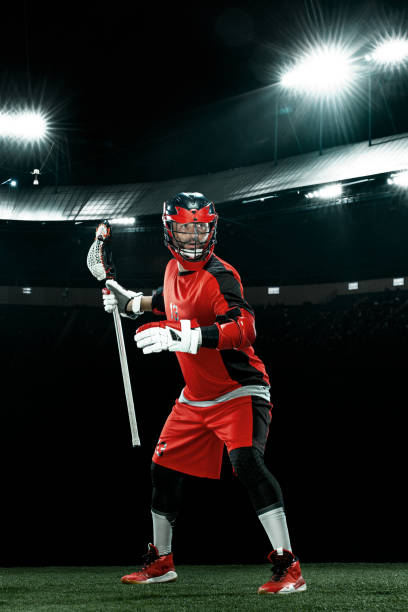 Lacrosse Player, athlete sportsman in red helmet on stadium background. Sport and motivation wallpaper. stock photo