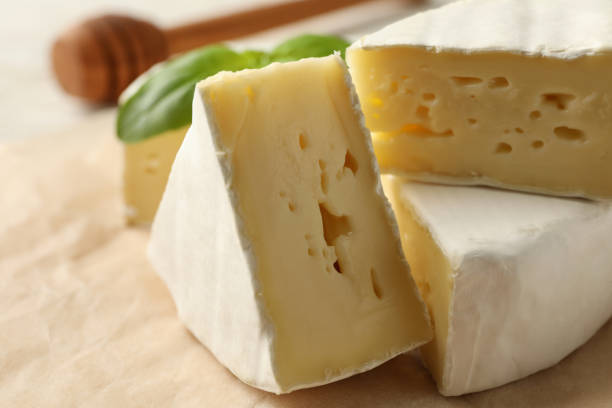 istock Baking paper with camembert cheese, basil and dipper 1299759717