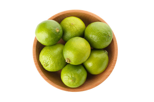 istock Bowl with ripe lime isolated on white background 1299760734