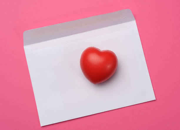 istock red heart and blank white paper on a pink background 1299761262