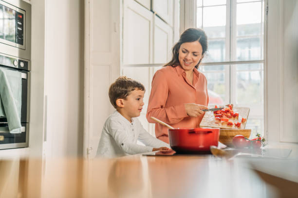 istock Mother and son chopping vegetables 1299761826