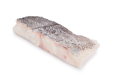 Fillet of raw hake cut out against a white background.