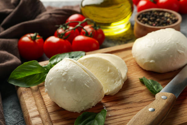 istock Concept of tasty eating with mozzarella on board on gray table, close up 1299762519