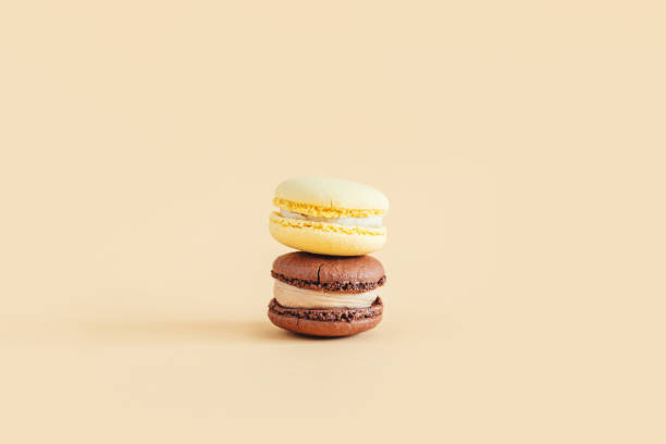 istock Tasty french macarons on a yellow pastel background. 1299762782