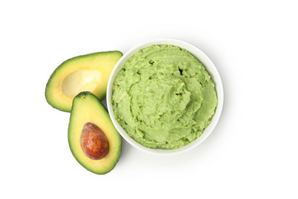 istock Bowl of guacamole and avocado isolated on white background 1299764183