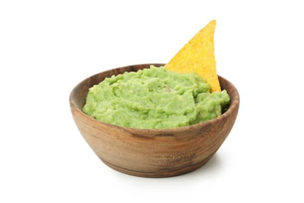 istock Bowl of guacamole with chip isolated on white background 1299764805
