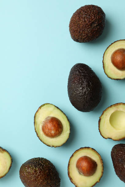 istock Ripe avocado on blue background, top view 1299764906