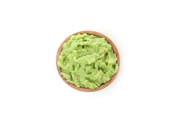 istock Bowl of guacamole isolated on white background 1299765224