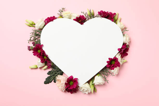istock Blank heart and different flowers on pink background, space for text 1299766101