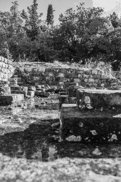 istock Old stone from roman ruined thermal baths black and white 1299766856