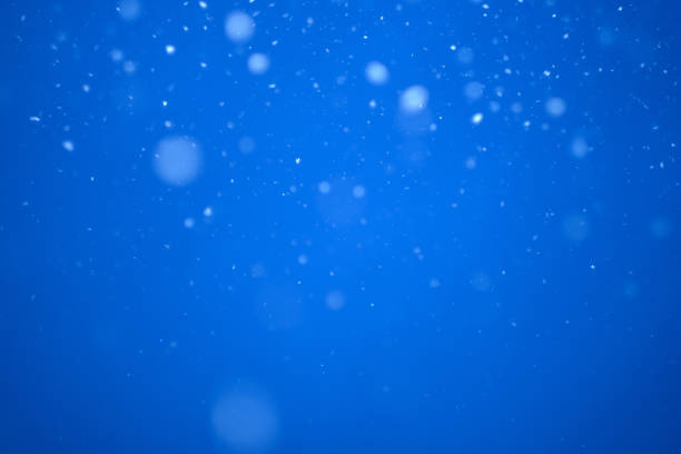 istock flying heavy snow on a black background of the blue sky 1299768387