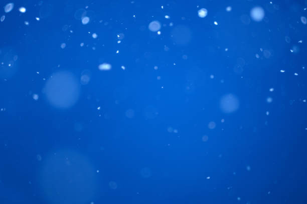 istock flying heavy snow on a black background of the blue sky 1299768949