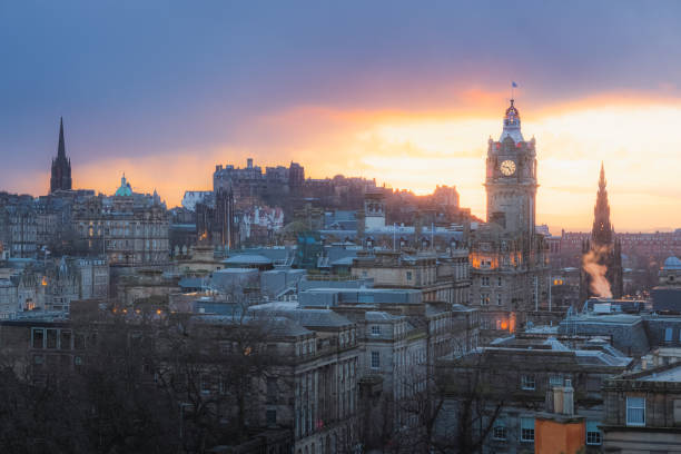 Dugald stewart monument standing on calton hill with a vibrant sunset over edinburgh