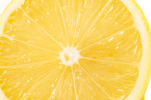 Macro close-up of a lemon slice on white background