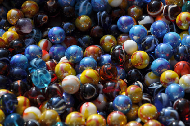 Multicolored glass marbles. Close view of colorful marbles. marble sphere stock pictures, royalty-free photos & images