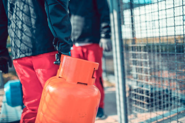 istock Liquified Gas Storage Team Refilling Cylinders 1299769469