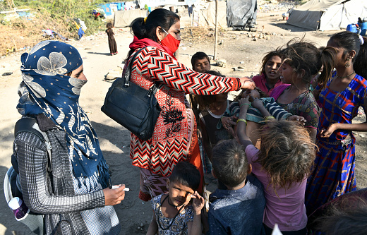 Beawar, Rajasthan, India, Feb. 01, 2021: An Anganwadi health worker administers polio vaccine drops to a child at a slum area during Pulse Polio eradication program in Beawar